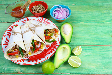 tacos with meat and vegetables - Mexican food style on a wooden background. Top view.の写真素材
