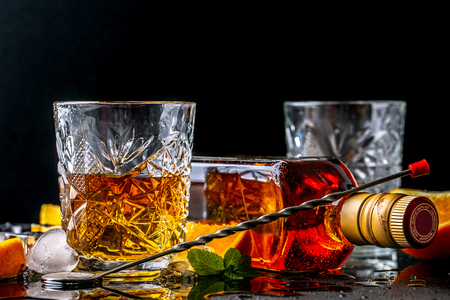 Elite drink for masculine relaxation Two glasses of whiskey and ice on black background, copy space.の写真素材