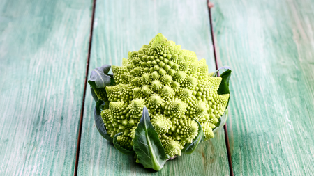 Healthy Green Organic Raw cabbage romanesco. Bunch of fresh green broccoli on a wooden board. top view, place for text.の写真素材