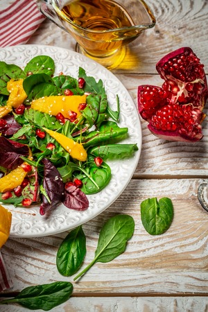 Mango with Pomegranate, lettuce and rocket salad. vertical image. Seasonal harvest crop local produce concept. Authentic lifestyle.の写真素材