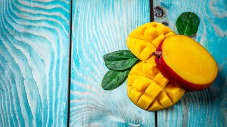 Mango. Tropical Fruits on a blue wooden background, copy space text, blank for text, top view.の写真素材