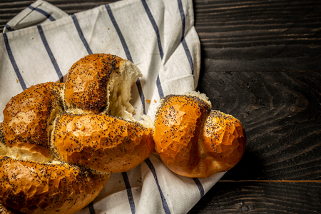 Traditional jewish bread brown challah on black wooden background with fruits and honey. concept of jewish cuisine. Flat lay. copy space.の写真素材