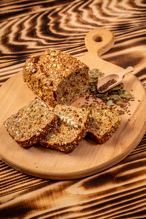 Whole grain bread with seeds of goji berry, pumpkin, flax and hemp, vertical image. space for text. top view.の写真素材
