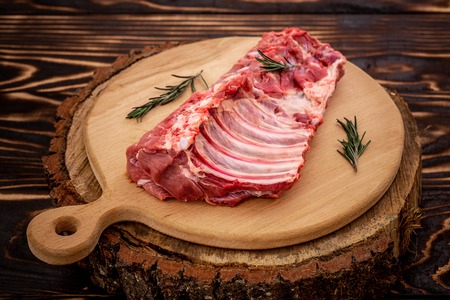 Raw sliced pork ribs on wooden serving board, Close up on wooden background. Food concept. top view.の写真素材