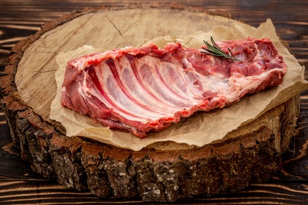 Raw ribs meat with herbs, salt, spices and other ingredients. Top flat view.