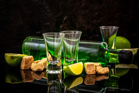 the concept of strong alcohol. Absinthe with a sugar cubes, lime slices. absinthe. space for text.の写真素材