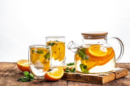 Water detox with orange, mint as lemonade refreshment. fitness, healthy nutrition diet concept. space for text.の写真素材