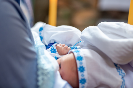 Infant baptism in the Church, the process of anointing on a white blankets, baptism Christening the baby at the Orthodox church.の写真素材