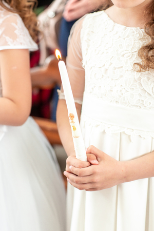 first communion girl. Hands of a little girl in the First Communion Day in the church.の写真素材