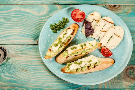 bruschetta with grilled cheese halumi on a wooden background. Preparation of cheese Halumi. Cheese Halumi with mint.の写真素材