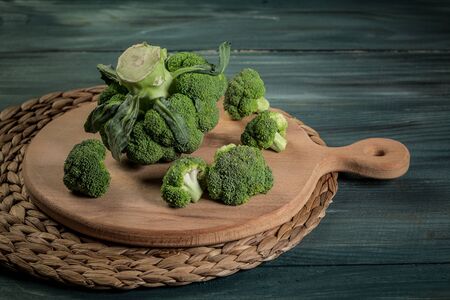 Fresh raw organic broccoli on wooden rustic background. Organic food.の写真素材
