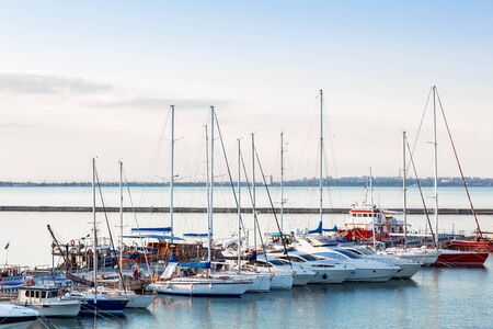 Sailboat harbor, many beautiful moored sail yachts in the sea port, modern water transport, summertime vacation, luxury lifestyle and wealth concept. harbor yacht club.の写真素材