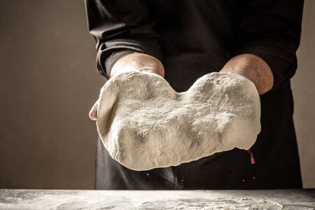 pizza prepare dough hand topping. Baking concept. chef with raw dough.の写真素材