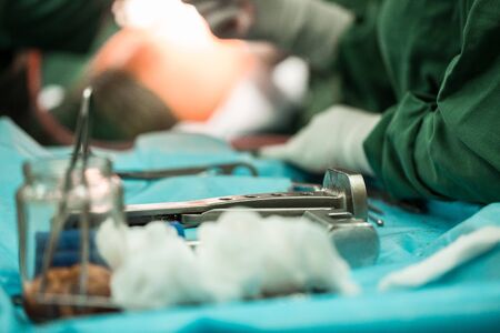 Operating Room of Surgical Table with Instruments, Assistant Picks up Instruments for Surgeons...