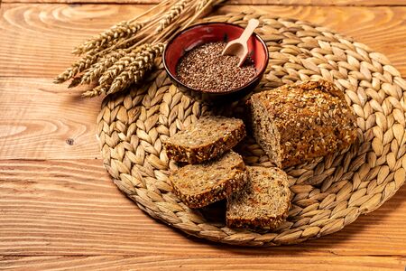 Dark rue bread with sunflower seeds on a white background.の写真素材