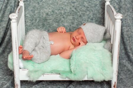 sleeping newborn baby in bright wrap. concept of happiness. place under the text.