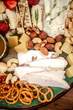 large assortment of international cheese specialities on black background. dairy products.の写真素材