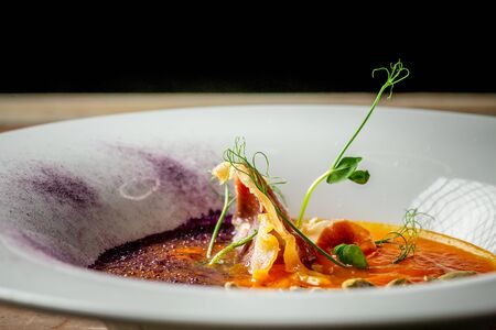 Pumpkin soup with fried bacon on wooden board. healthy food. place under the text.の写真素材