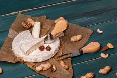 The concept of oriental cuisine. National Italian French Camembert or brie cheese in paper and...