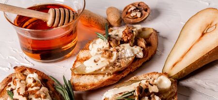 Close up pear and nuts brie crostini. Long banner format menu recipe.の写真素材