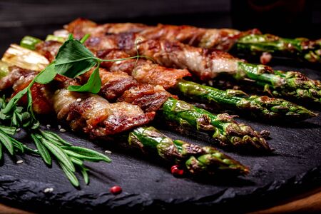 Grilled green asparagus wrapped with bacon. Ketogenic diet. Healthy food, diet menu. Top view, overhead, banner.の写真素材