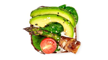 Bruschetta with grilled green asparagus, avocado, ricotta cheese and cherry tomato on white in the background.の写真素材
