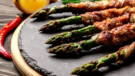 Tasty food bacon around asparagus. Detox and healthy concept. Keto food. Overhead.の写真素材