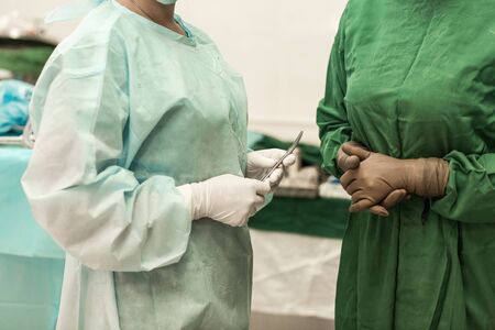 Healthcare workers in the Coronavirus Covid19 pandemic. Concentrated surgeons operating a patient in...