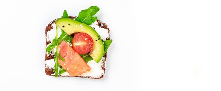 sandwich with salmon arugula, ricotta cheese and avocado on a white background. Top view. Long...