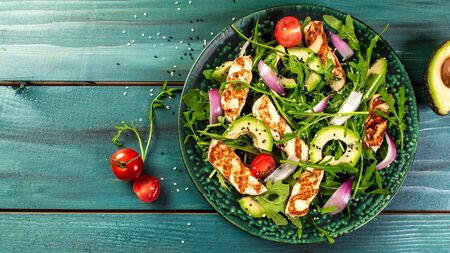 Fresh salad with fruits and greens on white wooden background top view with space for text. Healthy food.の写真素材