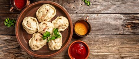 The concept of oriental cuisine. Uzbek food Manti or manty dumplings restaurant concept. Homemade Uzbek dish. recipe background. space for text. top view.の写真素材
