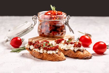 Bruschetta with cheese, sun-dried tomatoes and garlic.の写真素材
