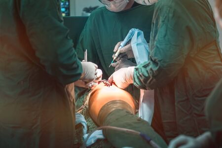hip replacement surgery in progress, open cavity with scalpel and soft-tissue retractors. Orthopedic...