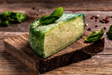 Cheese with hard crust, pesto sauce, spirulina. Bulgarian green cheese. banner menu recipe place for text.の写真素材