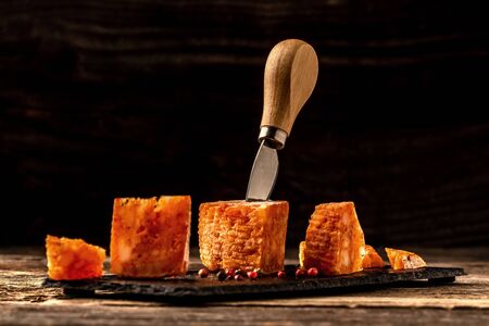 spicy cheese with pepper, tomato sauce on a wooden table. eco product. space for text.の写真素材