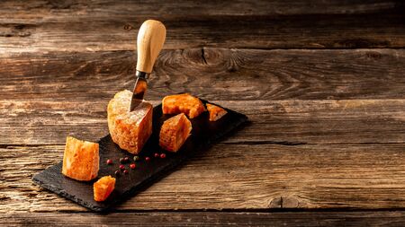Mexicana spicy cheese with chili and tomato on cutting board on a wooden table. Long banner format. space for text.の写真素材