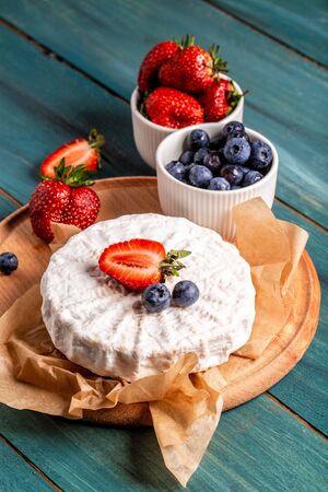 Fresh strawberries and brie cheese wooden board. banner menu recipe place for text.の写真素材