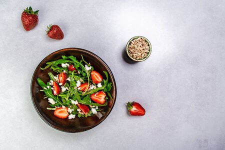 Strawberry salad with arugula and cheese. Healthy food. banner menu recipe place for text, top view.の写真素材