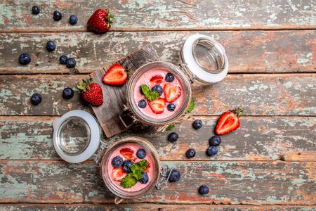 dessert panna cotta with mousse Greek yogurt or cream dessert with fresh strawberry blueberries. banner menu recipe top viewの写真素材