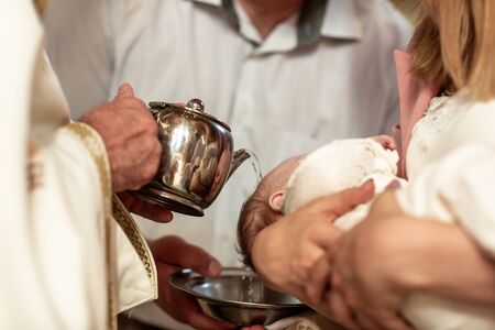 Baptism ceremony in Church, water, catholic. The Sacrament of Baptism. Attributes.