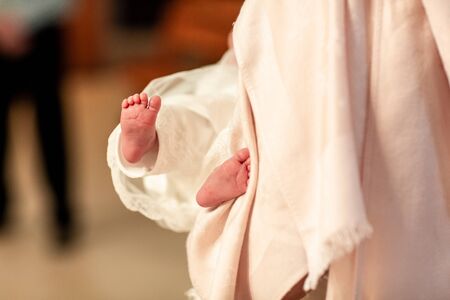 little girl and a cross at the ceremony of baptism. Baptism ceremony in Church, catholic.