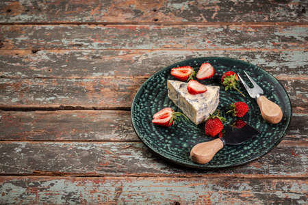 Blue and brie cheese. served with strawberry. The concept of eco products. Background image. Copy...