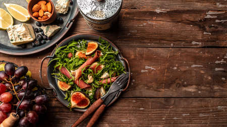 Prosciutto salad with figs and blue cheese. Long banner format, top view.の写真素材