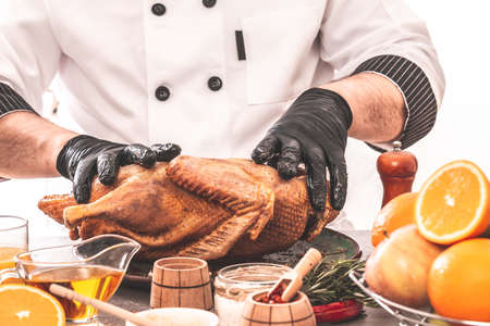 Cooking chef duck sprinkled with seasonin for the festive table, Independence Day of the United States, Day of Grace, Christmas. menu recipe place for textの写真素材