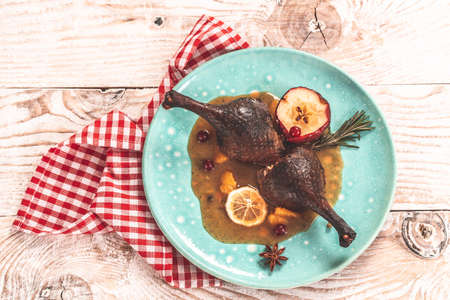 Crusty goose with leg citrus fruit and prune sauce. Cooking at Christmas time, banner, catering menu recipe place for text, top viewの写真素材