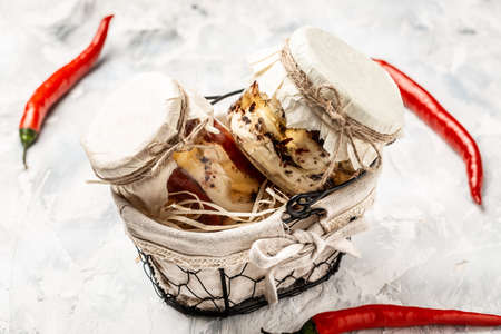 Cheese in marinade, variety of homemade cheese in small jarの写真素材