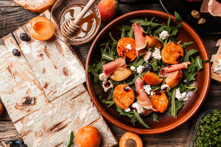 Grilled peach salad with lettuce, blue cheese, prosciutto, dor blue cheese, Delicious breakfast or snack, top view.の写真素材