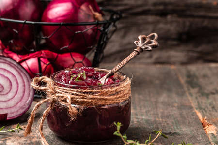 Homemade DIY natural healthy red onion marmalade jam, confiture, chutney in jar. Vegetable jam on wooden background. French cuisine, banner formatの写真素材