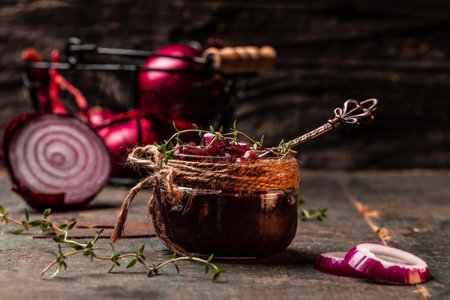 Homemade onion marmalade jam, confiture, chutney on a rustic wooden table. Delicious sauce. French cuisine, catering, banner, menu, recipeの写真素材