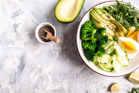 Healthy salad meal with egg, avocado and mixed fresh vegetables on a light background, Healthy meal concept, top view.の写真素材